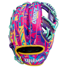 The Wilson A2000 1786SS 11.5" GOTM January 2026 baseball glove features bold abstract pink, yellow, teal, and purple patterns, teal lacing, durable SuperSkin material, and "A2000" and "Wilson" in white.