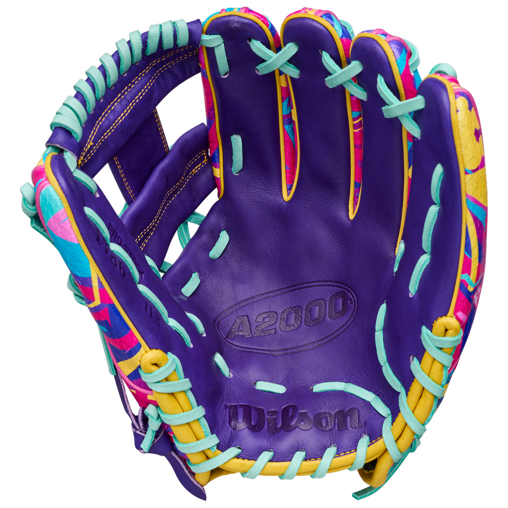 The Wilson A2000 1786SS 11.5" Baseball Glove GOTM January 2026 features Pro Stock leather in purple, aqua blue laces, yellow accents, and vibrant pink and yellow patterns on the inner sides.