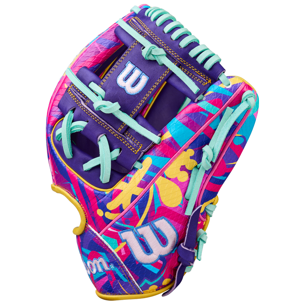 The Wilson A2000 1786SS 11.5" GOTM January 2026 baseball glove features a vibrant abstract design in pink, purple, yellow, and blue with turquoise laces, Pro Stock leather, and a bold white W logo on the back.