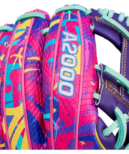 Close-up of the Wilson A2000 1786SS 11.5" Baseball Glove (GOTM January 2026) featuring a vibrant abstract pattern in pink, purple, teal, and yellow with stitched A2000 text on Pro Stock leather.