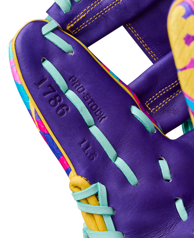 Close-up of the Wilson A2000 1786SS 11.5" Baseball Glove (GOTM Jan 2026), featuring teal laces, yellow accents, and colorful patterns. Made from premium Pro Stock leather, with "1786" and "11.5" embossed on the palm area.