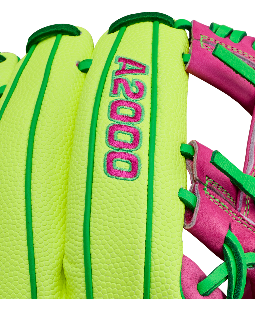 A close-up of the Wilson A2000 1975SS 11.75" Baseball Glove (GOTM March 2026) in neon yellow-green with pink and green accents, featuring embroidered A2000 text—showcasing its unique Wilson Glove of the Month design.