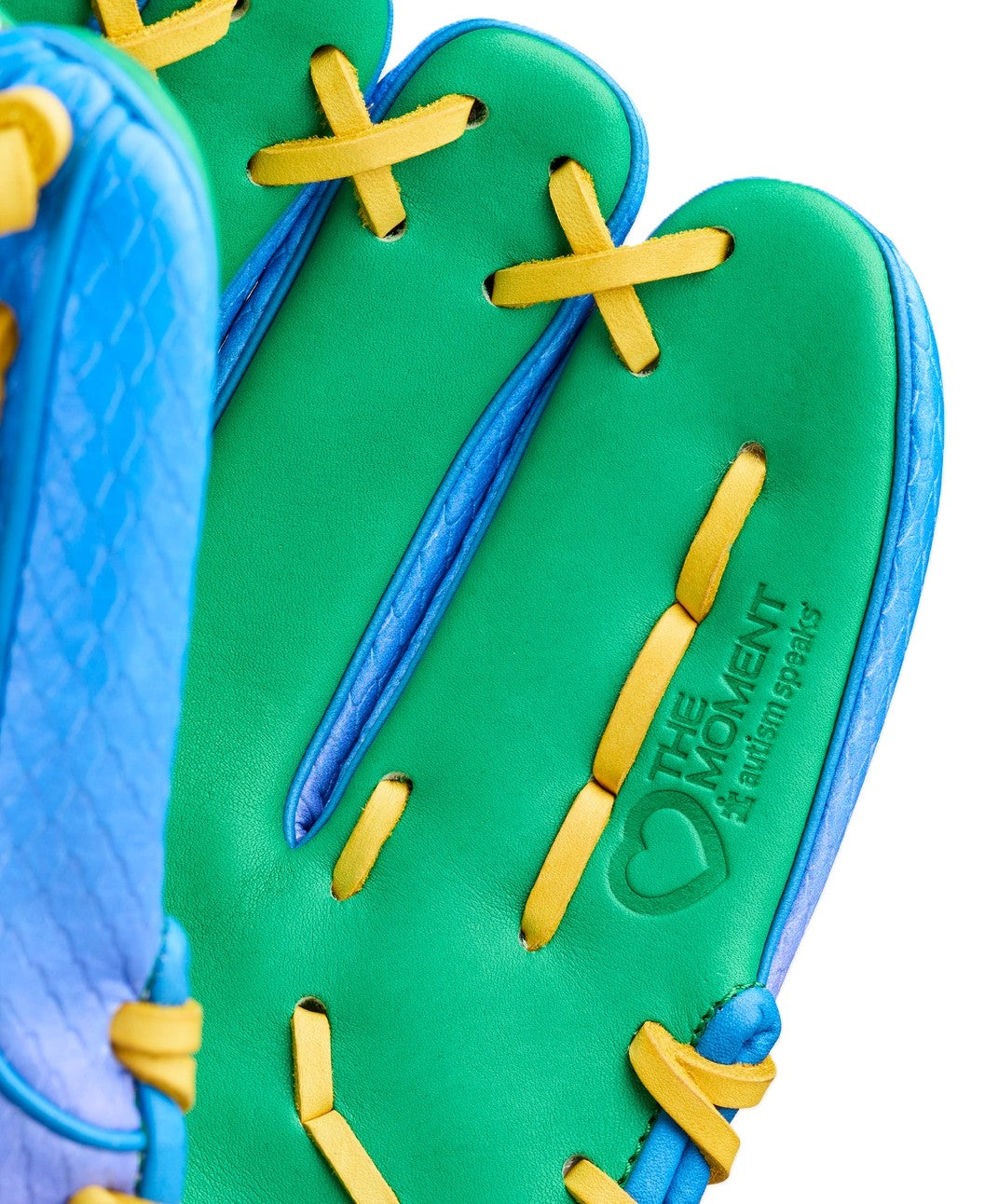 Close-up of the Wilson Love the Moment A2000 1786SS 11.5" Noah’s Edition glove, featuring green, blue, yellow colors, “THE MOMENT,” a heart symbol, Autism Speaks details, and yellow laces. Model: WBW104826115.