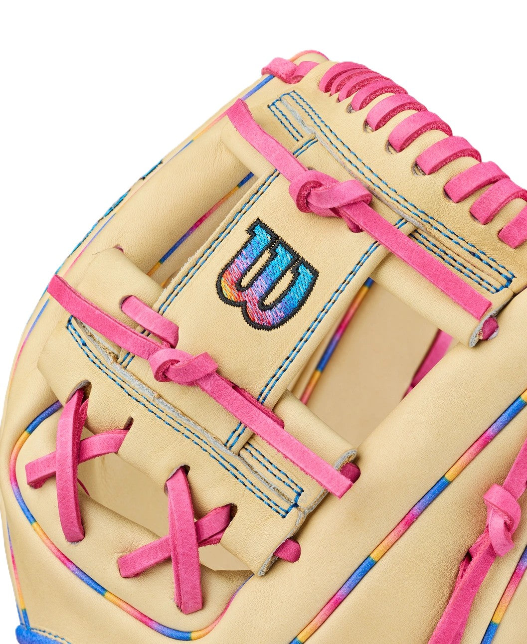 A close-up of the Wilson Love the Moment A2000 1786 11.5" Baseball Glove with beige leather, bright pink laces, blue stitching, rainbow accents, and a black-and-blue embroidered “W” logo on the back.