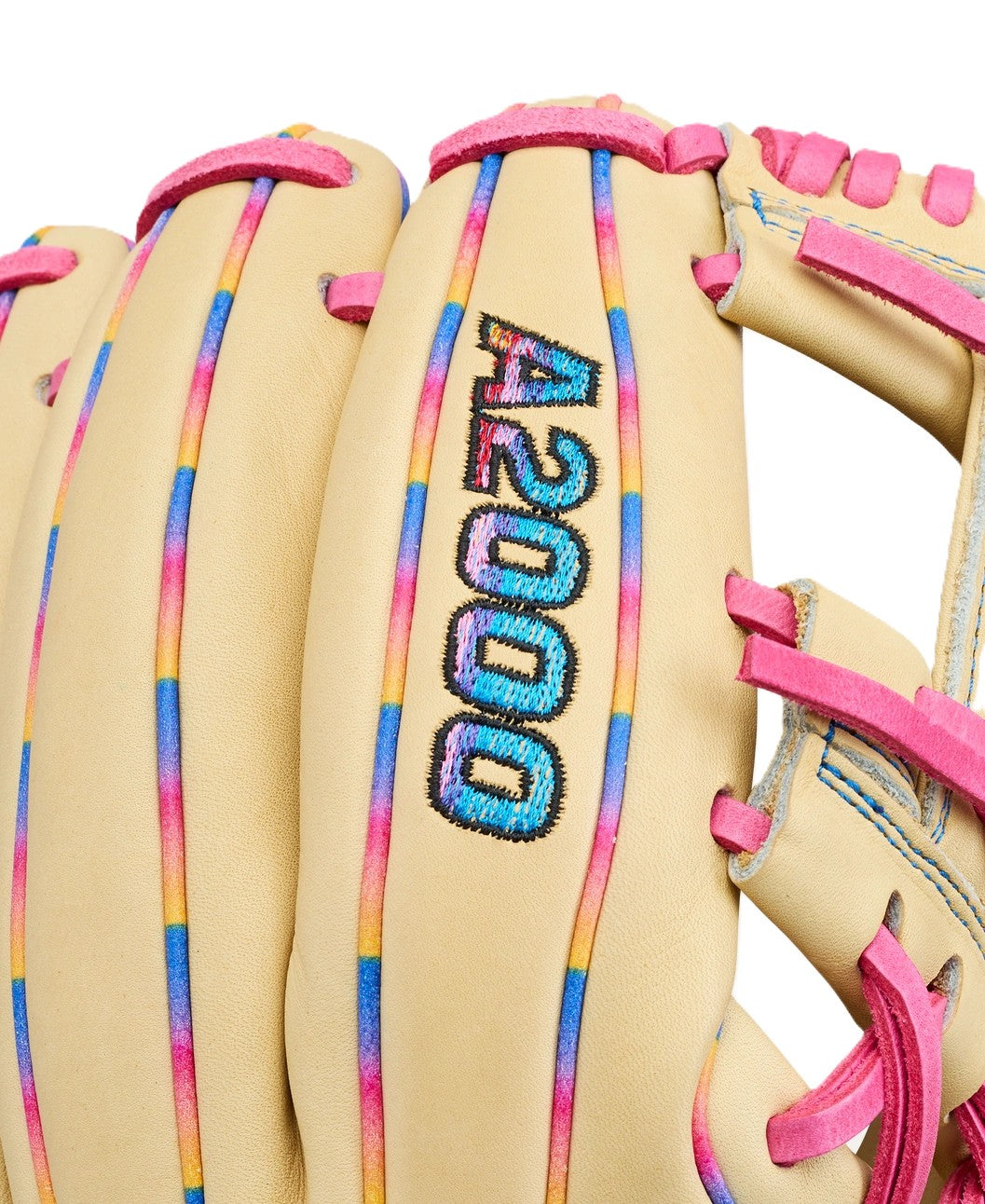 A close-up of the Wilson Love the Moment A2000 1786 11.5" baseball glove, featuring tan Pro Stock Leather with pink laces and blue, pink, and yellow accents. The A2000 model number is stitched in multicolored thread on the glove.