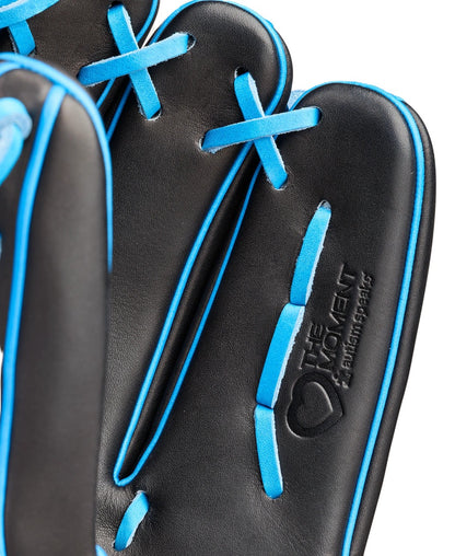 Close-up of the Wilson Love the Moment A2000 B23 12" Baseball Glove (WBW10482912) in black with bright blue laces, embossed text, and a heart logo reading "THE MOMENT & EVERYTHING BEHIND IT." Made from Pro Stock Leather.