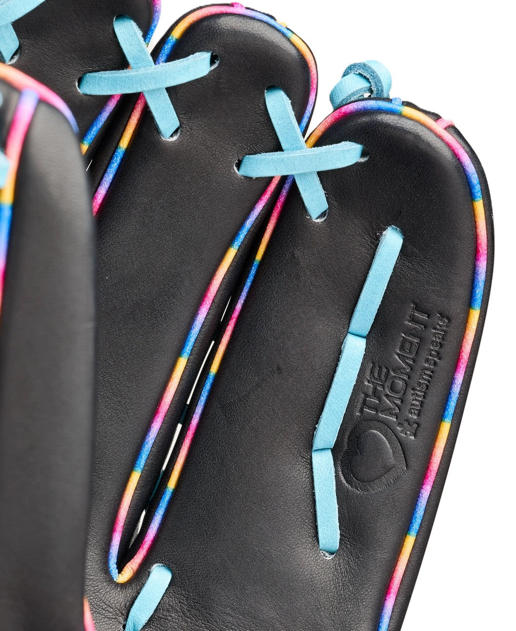 Close-up of a black leather Wilson Love the Moment A2000 1750 12.5" Baseball Glove with colorful rainbow-edged seams, light blue laces, and embossed with THE MOMENT and AMERICAN KIPSKIN near the palm.
