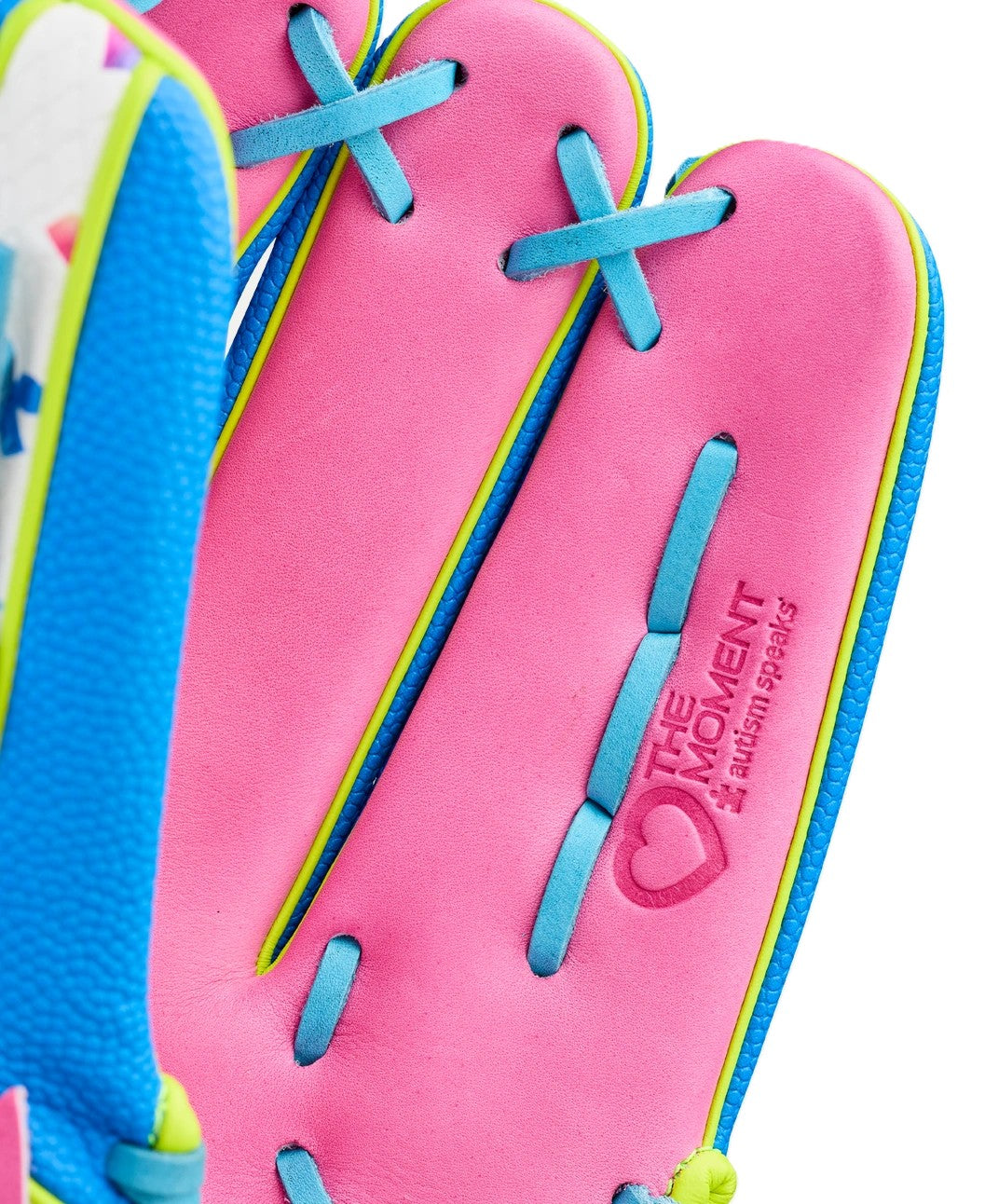 Close-up of the Wilson Love the Moment A2000 1777 12.75" Baseball Glove (WBW1048331275), featuring bright pink, blue, and yellow sections. "THE MOMENT" and a heart are embossed on the pink part with ALL RIGHTS RESERVED.