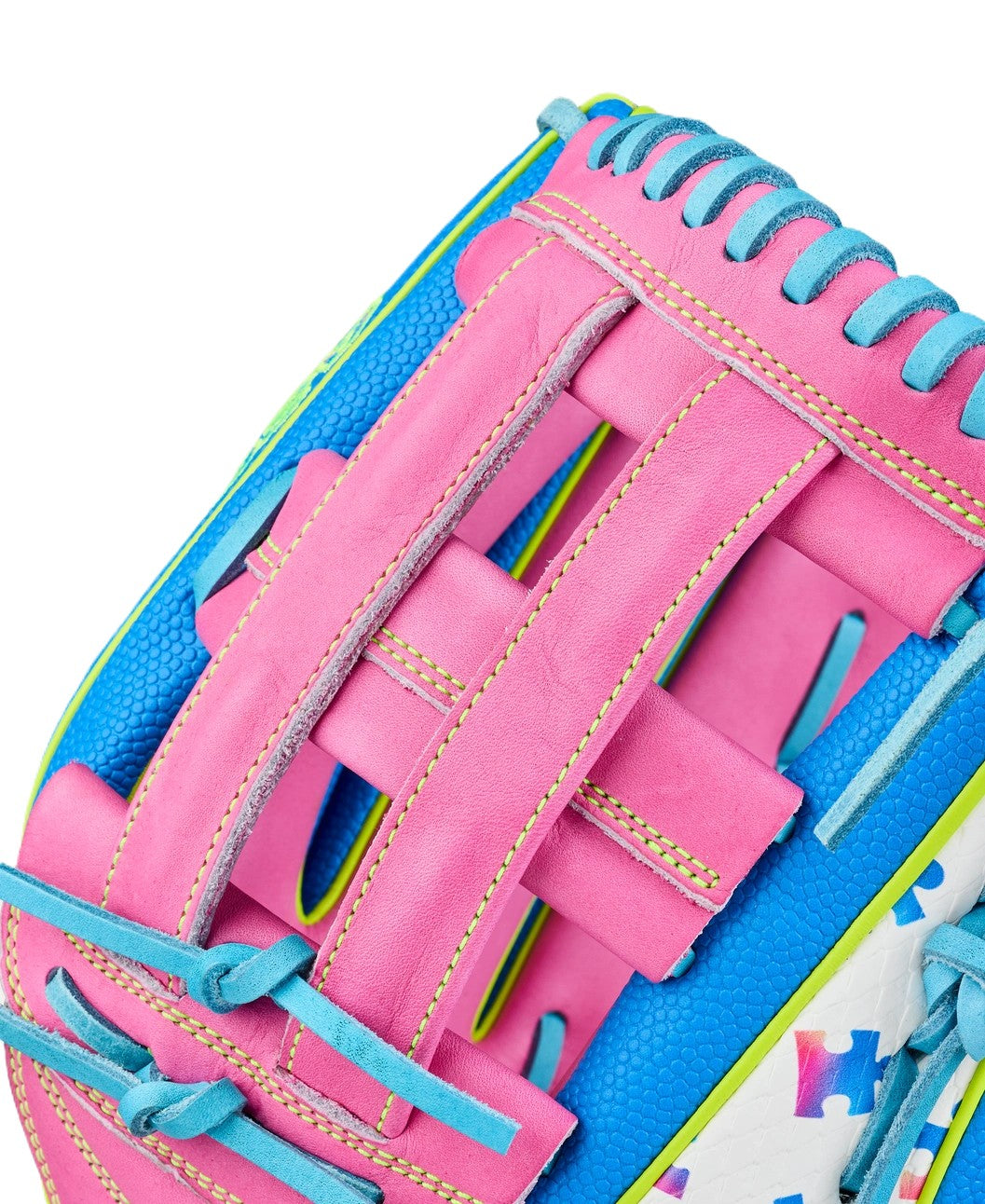 Close-up of the Wilson Love the Moment A2000 1777 12.75" Baseball Glove (WBW1048331275) featuring pink leather laces, blue accents, yellow stitching, and a white surface with multicolored star patterns.