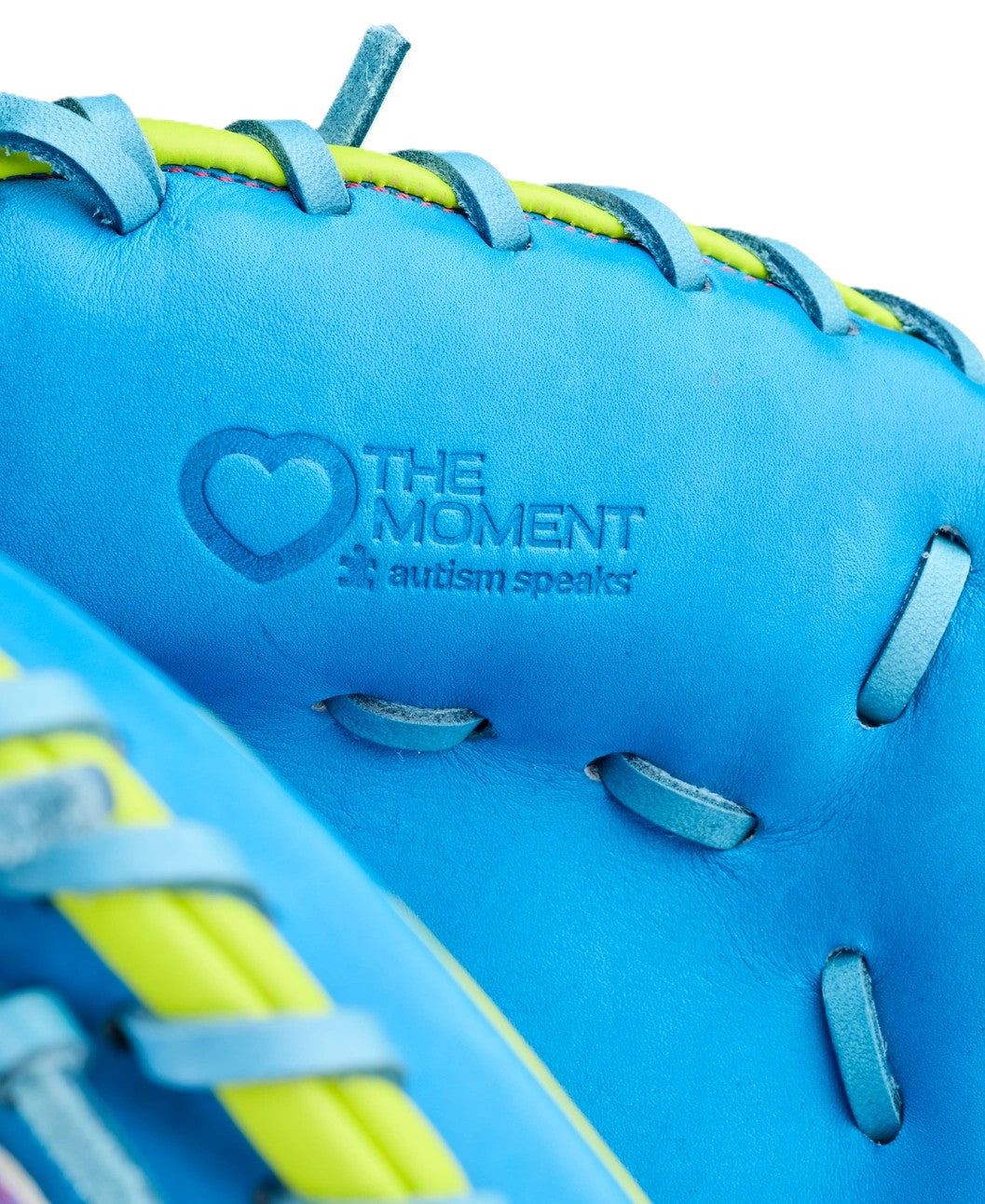 Close-up of the Wilson Love the Moment A2000 CM33SS 33" Catcher's Mitt, featuring Pro Stock Leather in bright blue with yellow and blue laces, embossed with THE MOMENT, autism speaks, and a heart symbol.