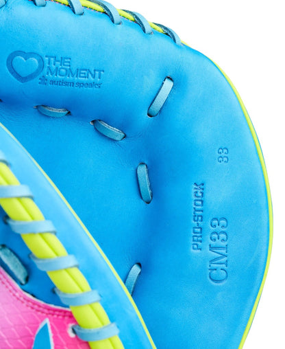 Close-up of Wilson’s Love the Moment A2000 CM33SS 33" Baseball Catcher's Mitt (WBW10483533) in bright blue with yellow and pink accents, featuring text inside reading THE MOMENT, PRO STOCK LEATHER, 33, and CM33.