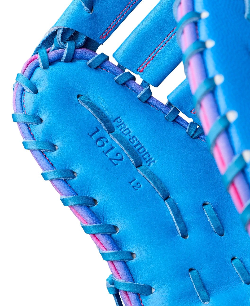 Close-up of the Wilson Love the Moment A2000 1612 12" First Base Mitt, featuring bright blue Pro Stock leather with pink and blue lacing, inspired by Autism Speaks. "PRO STOCK 16:12 12" is embossed on the leather near the center.