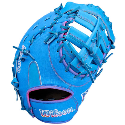 The Wilson Love the Moment A2000 1612 12" First Base Mitt (WBW10483812) features bright blue Pro Stock Leather, pink accents and lacing, an open web design, and the Wilson logo embroidered on the wrist strap.