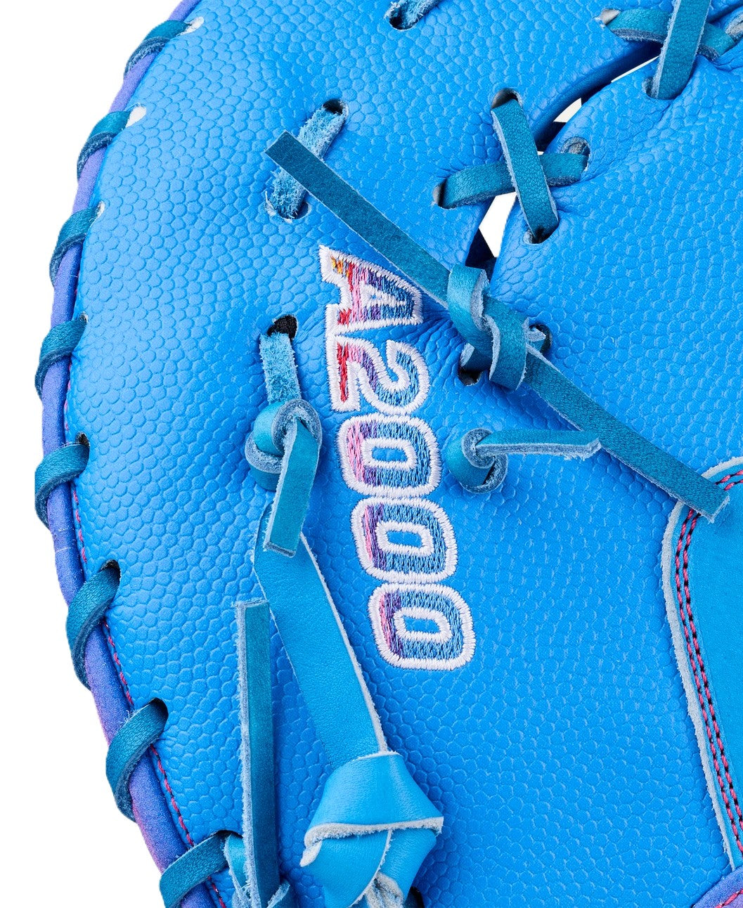 Close-up of the Wilson Love the Moment A2000 1612 12" Baseball First Base Mitt (WBW10483812), featuring bright blue Pro Stock Leather, blue laces, and 'A2000' stitched in white and red, modeled after the iconic A2000 1612 mitt.