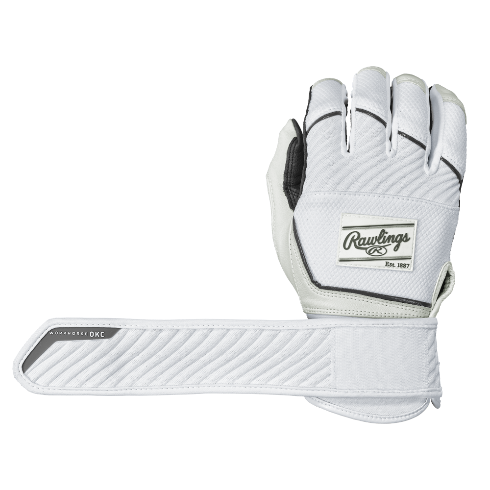 A pair of Rawlings Workhorse OKC Compression Strap Women's Batting Gloves is displayed—one glove palm down, the other showing the underside and its extended compression strap labeled WORKHORSE OKC. The gloves are white with black trim.