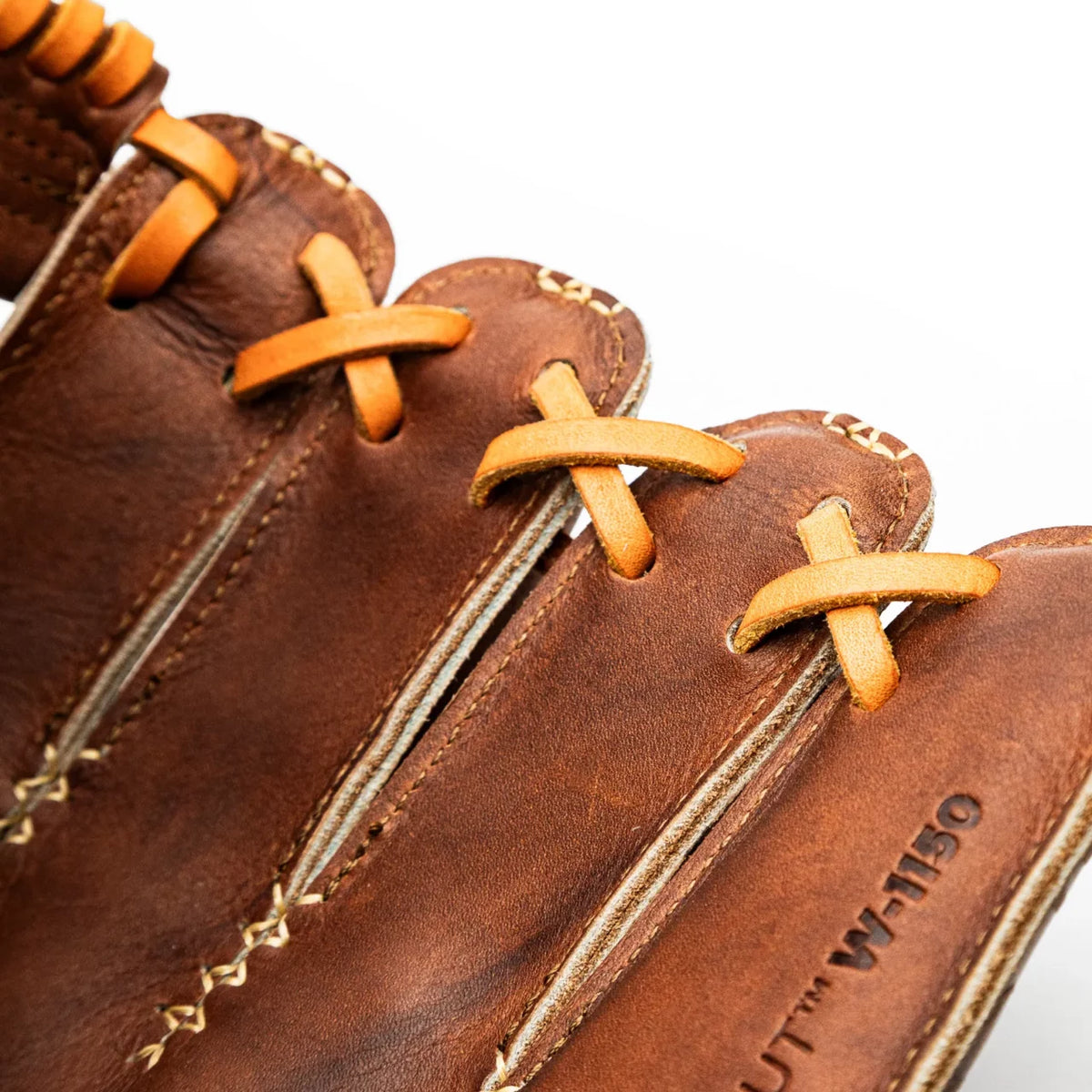 Close-up of the web and fingers of a handcrafted Nokona Walnut EP 11.5″ Baseball Glove: W-EP1150, featuring Walnut Crunch leather and tan lacing.