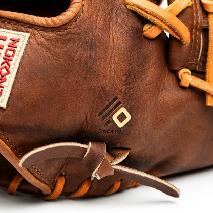 Close-up of a handcrafted Nokona Walnut EP 11.5″ Baseball Glove: W-EP1150, featuring brown leather, tan lacing, and a metal logo detail.