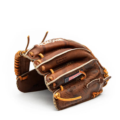 A brown leather Nokona Walnut EP 11.5″ Baseball Glove: W-EP1150 with tan lacing, featuring a small American flag patch and embossed finger detailing.