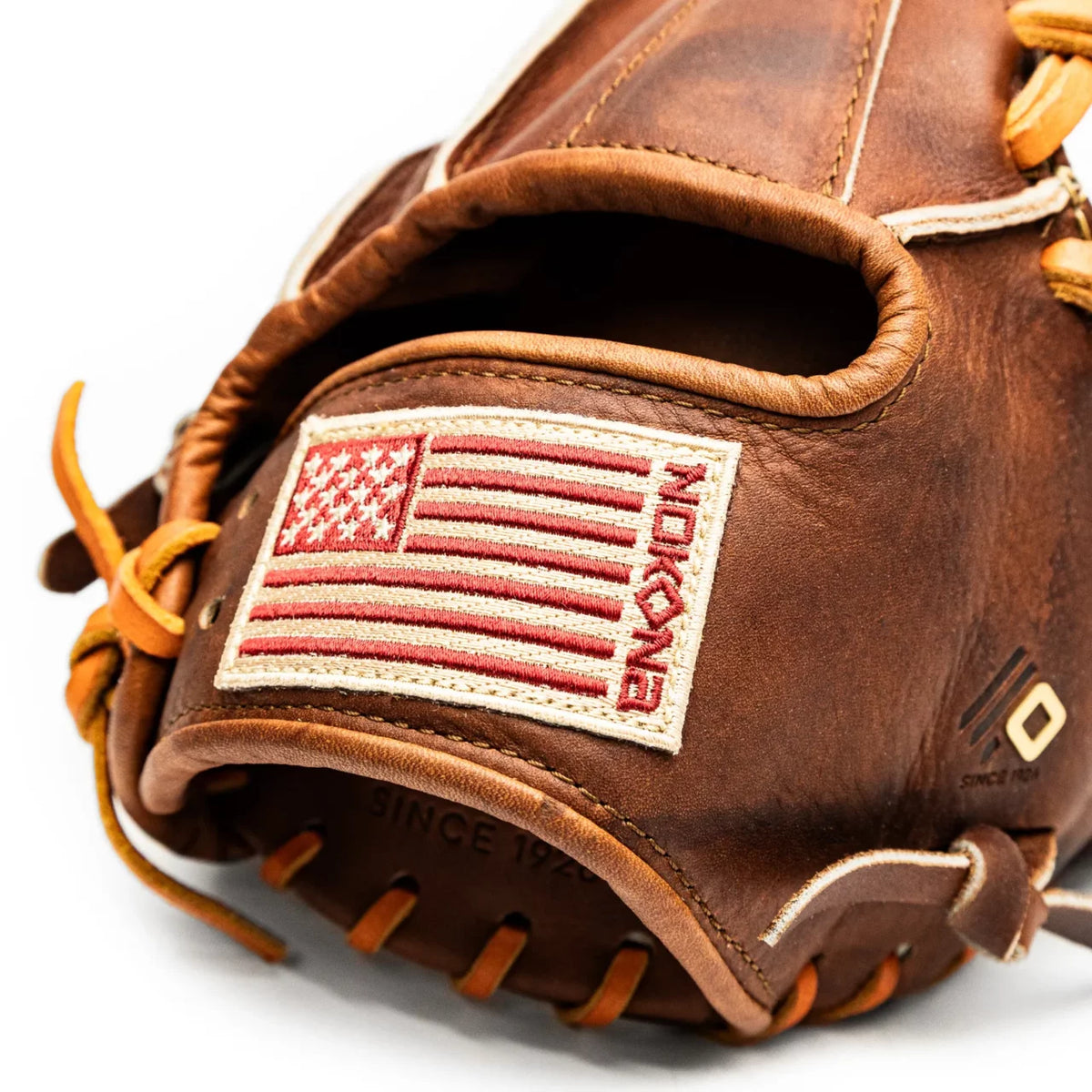 Nokona Walnut EP 11.5″ Baseball Glove: W-EP1150 in brown leather, featuring an American flag patch and a red brand logo on the wrist strap.