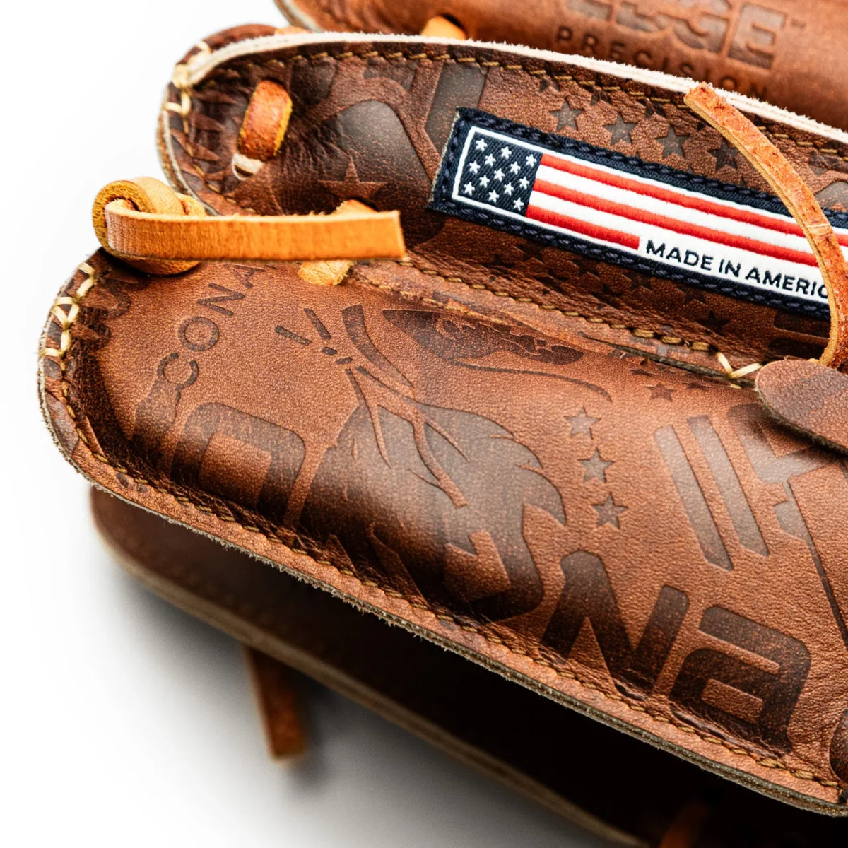Close-up of a handcrafted Nokona Walnut EP 11.5″ Baseball Glove: W-EP1150 featuring a debossed logo pattern and a small American flag patch.
