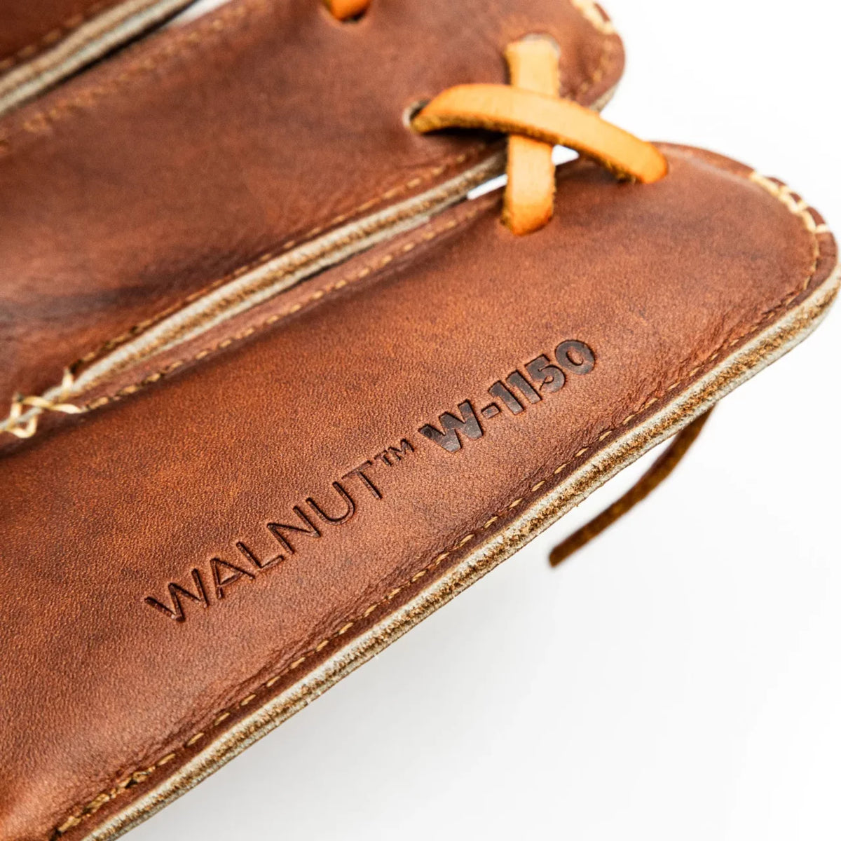 Close-up of a handcrafted Nokona Walnut EP 11.5″ Baseball Glove: W-EP1150, stamped with WALNUT W-1150.