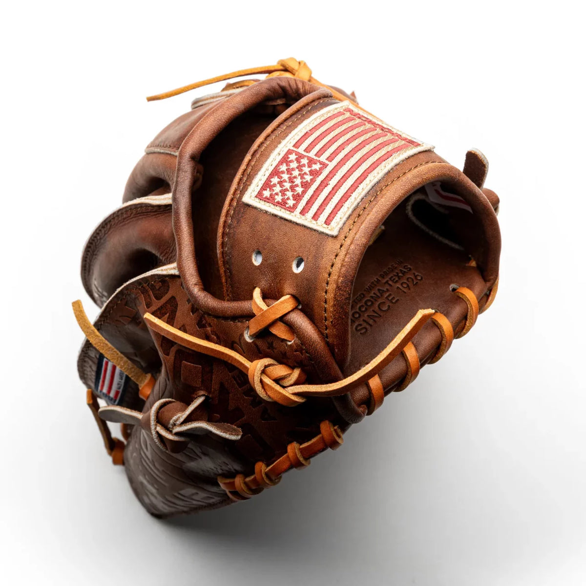 Brown Nokona Walnut EP 11.75″ Baseball Glove: W-EP1175 featuring an American flag patch on the wrist strap and embossed text that reads Made with pride in Nokona, Texas since 1926.