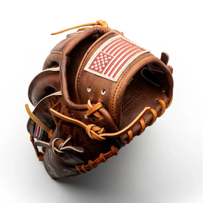 Brown Nokona Walnut EP 11.75″ Baseball Glove: W-EP1175 featuring an American flag patch on the wrist strap and embossed text that reads Made with pride in Nokona, Texas since 1926.