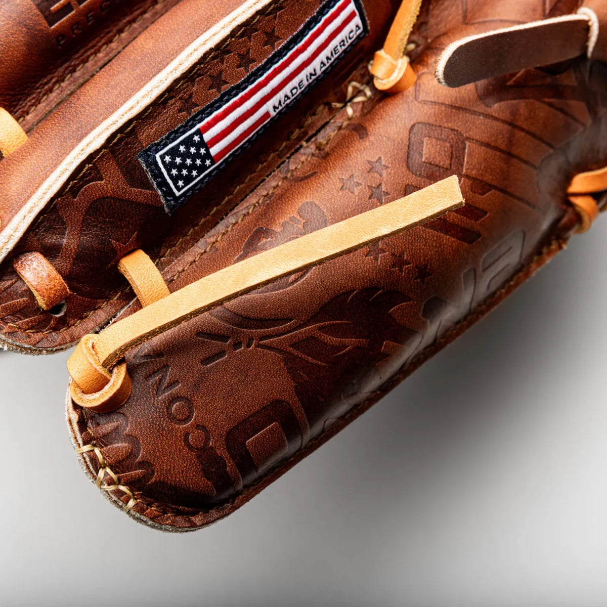 Handcrafted brown leather Nokona Walnut EP 11.75″ Baseball Glove: W-EP1175 featuring a Made in America flag patch and embossed star and text patterns.