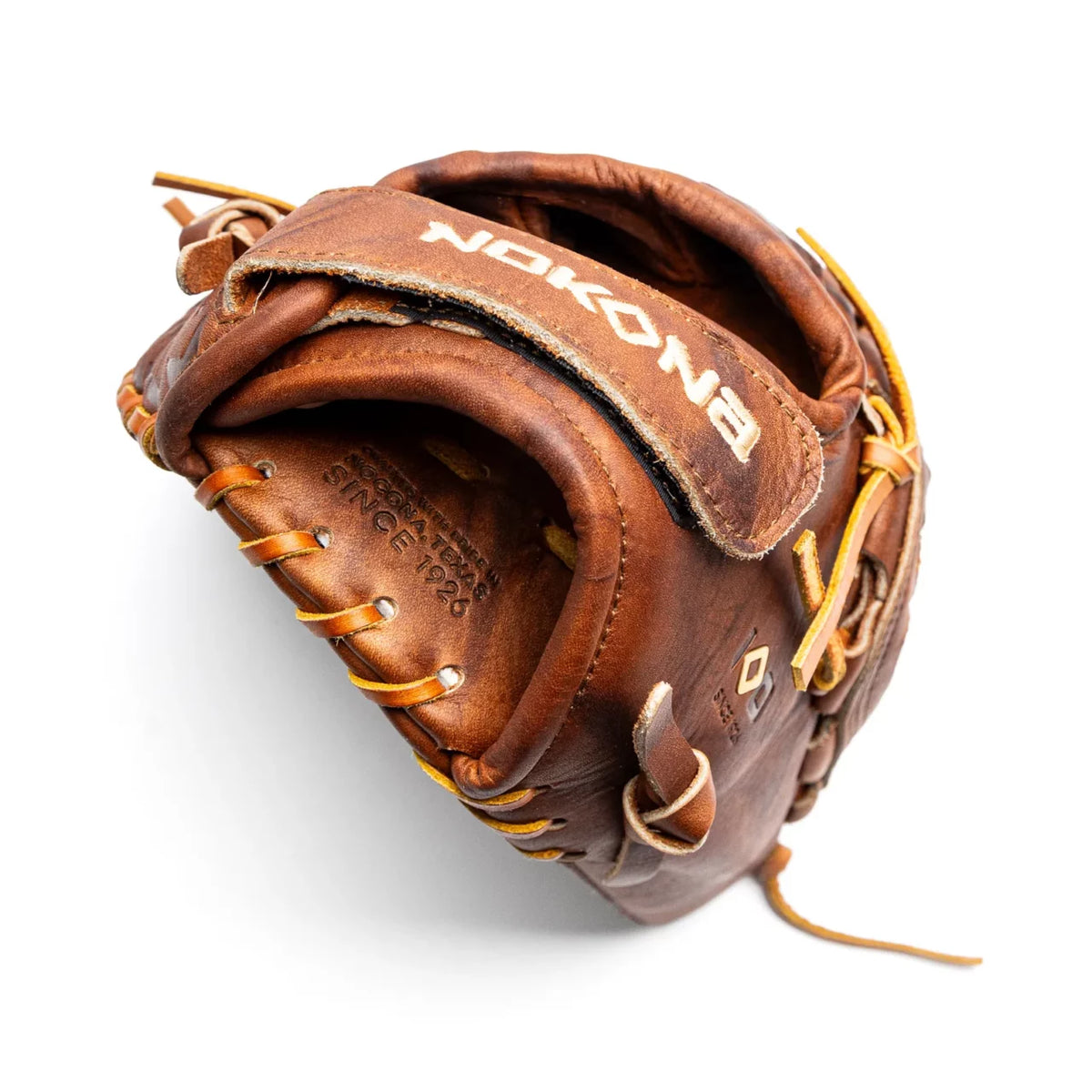 Nokona Walnut EP 12″ Fastpitch Glove: W-EP-V1200 handcrafted from brown leather with yellow lacing and embossed branding on the palm and wrist strap.