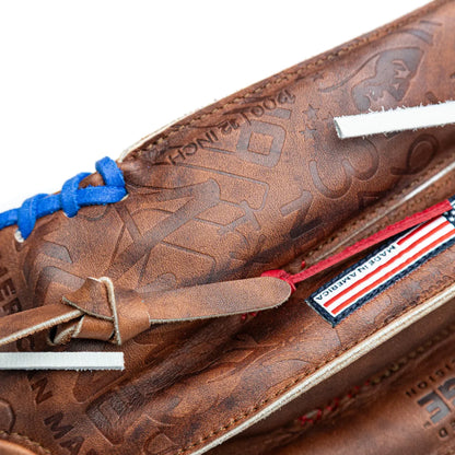 Close-up of a brown Walnut Crunch Nokona Walnut EP 12″ Baseball Glove: W-EP1200POP featuring a pattern of embossed logos, blue lacing at the wrist, and a Made in America flag patch.