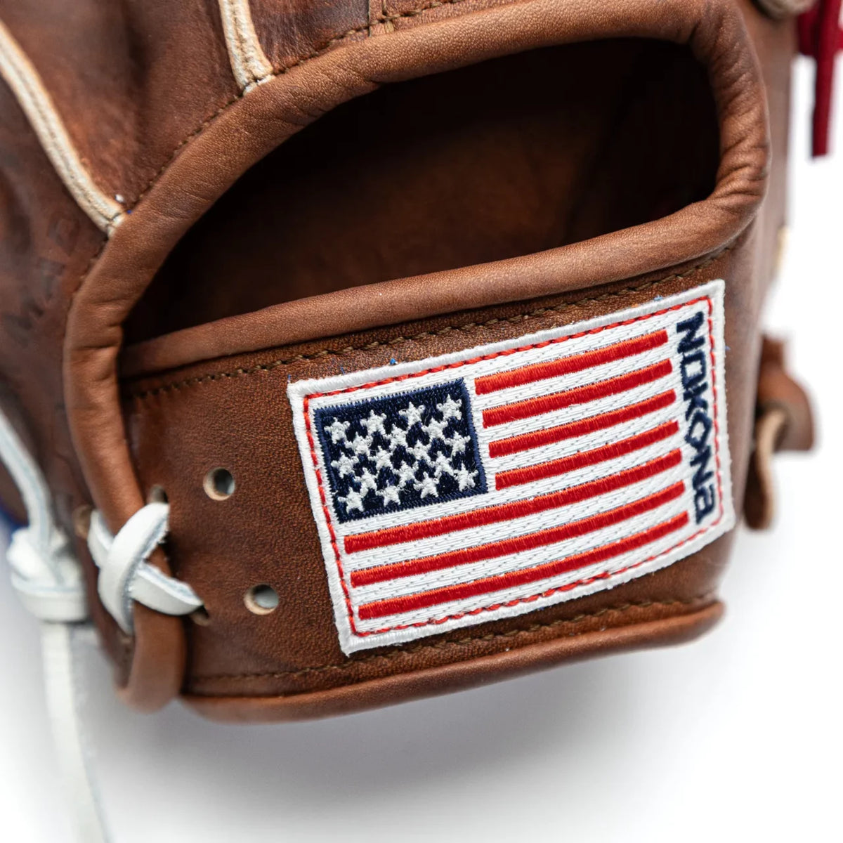 Close-up of a Nokona Walnut EP 12″ Baseball Glove: W-EP1200POP featuring a rectangular patch of the American flag with the brand name embroidered vertically along the side.