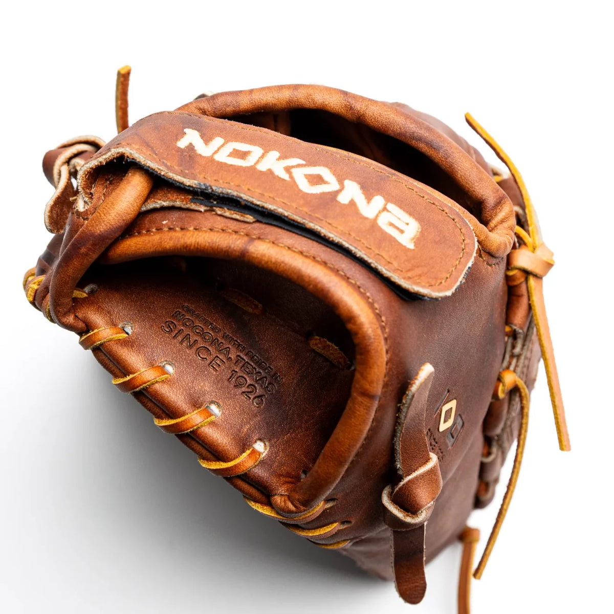 Nokona Walnut EP 12.5″ Fastpitch Glove: W-EP-V1250, a handcrafted Walnut Crunch leather glove with a strap across the back featuring embroidered text.