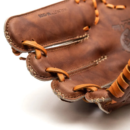 Close-up of a brown Walnut Crunch Nokona Walnut EP 13″ Baseball Glove: W-EP1300C showing the laced webbing between the fingers.