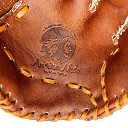 Close-up of a 13″ closed web Nokona Walnut EP 13″ Fastpitch Glove: W-EP-V1300, featuring a stamped logo of a Native American profile and the text American Made, Nocona, Texas.