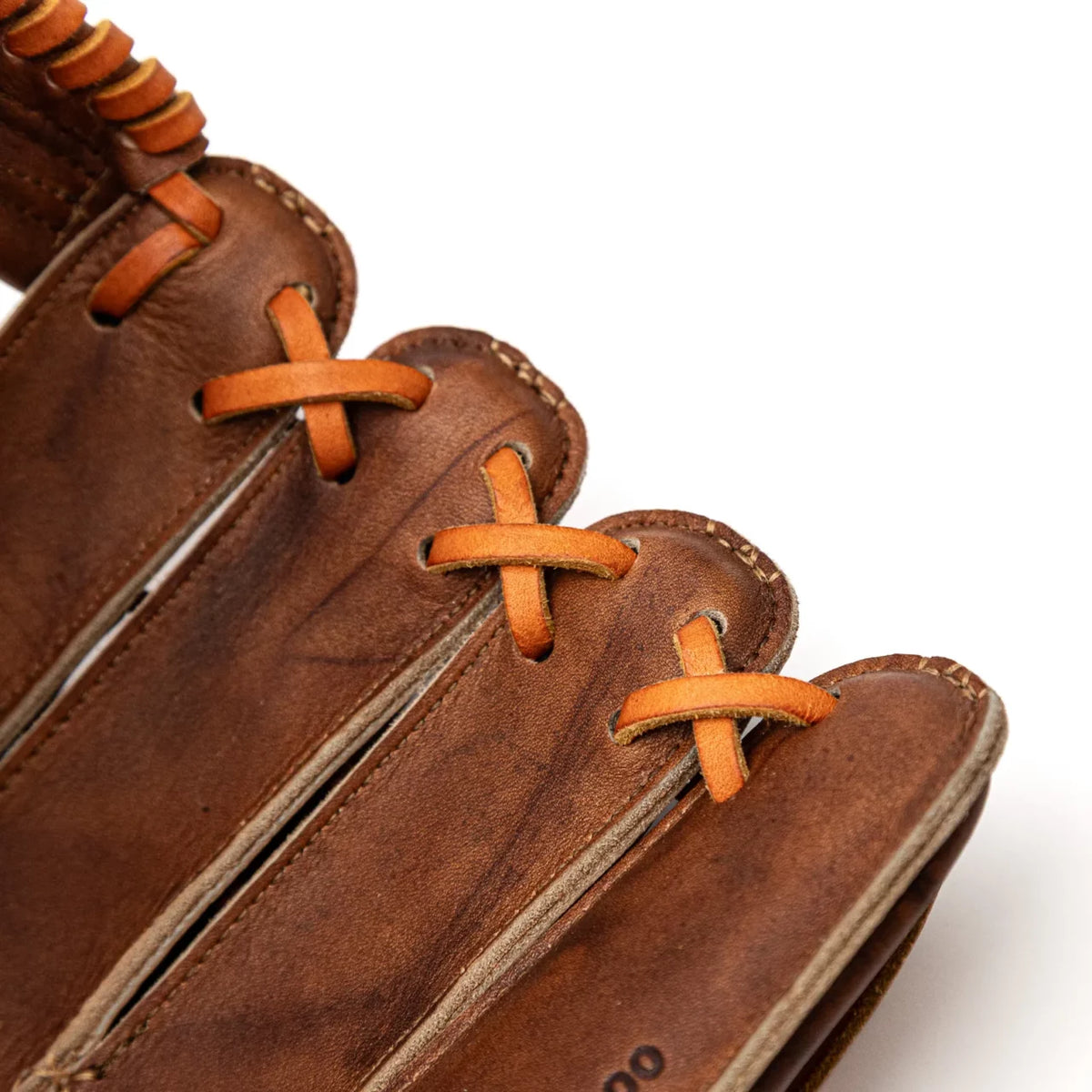 Close-up view of the fingers of a brown leather Nokona Walnut EP 13″ Baseball Glove: W-EP1300H with tan lacing.