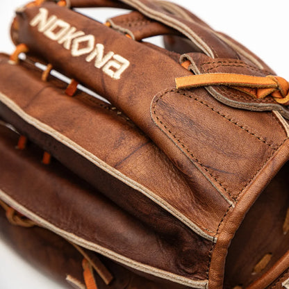 Close-up of a brown Nokona Walnut EP 13″ Baseball Glove: W-EP1300H with tan lacing and a white brand name embroidered on the top.
