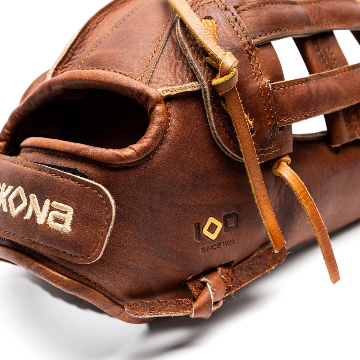 Brown leather Nokona Walnut EP 13″ Fastpitch Glove: W-EP-V1300H showing the wrist strap, lacing, and a commemorative 100 Since 1926 emblem.