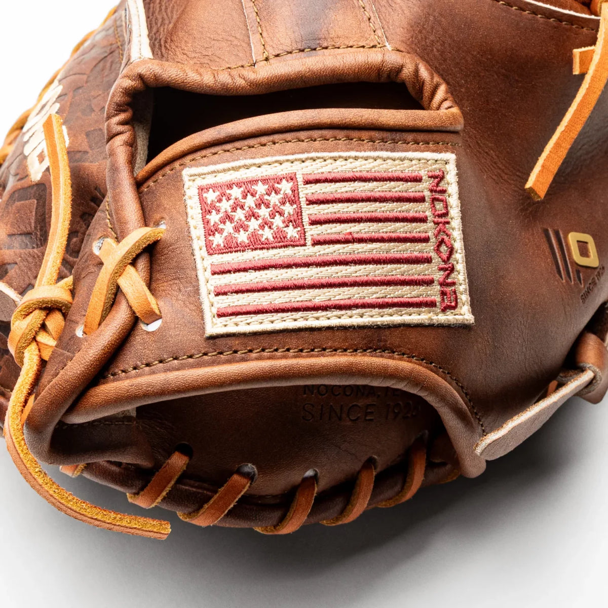 Brown leather Nokona Walnut EP 33.5″ Baseball Catcher’s Mitt: W-EP3350 featuring an embroidered American flag patch on the wrist strap.