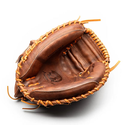 Brown leather Nokona Walnut EP 33.5″ Baseball Catcher’s Mitt: W-EP3350 with tan rawhide lacing.