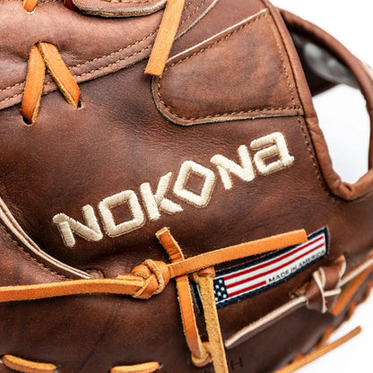 Nokona Walnut EP 13″ First Base Mitt: W-EPN70 in Walnut Crunch leather with light tan laces, featuring an embroidered Nokona brand name and a small American flag tag.