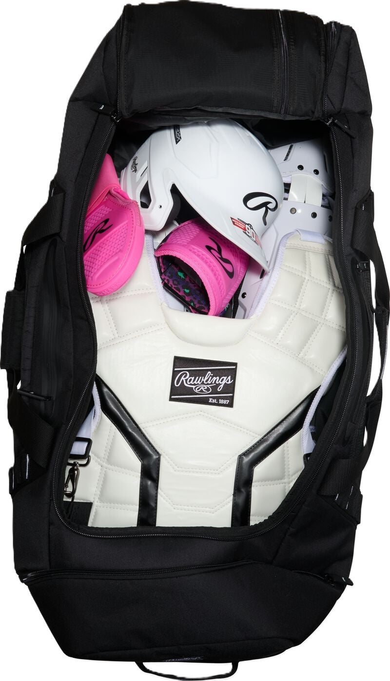Black Rawlings Yadi 2 Luggage Wheeled Catcher’s Bag: YADI2LUGG packed with a white catcher’s chest protector, a white batting helmet, and pink batting gloves.