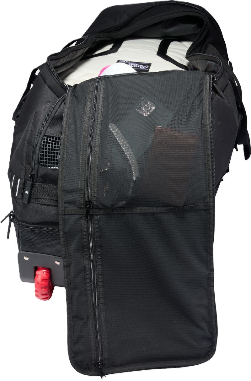 Black Rawlings Yadi 2 Luggage Wheeled Catcher’s Bag with an open zippered compartment, revealing a mesh storage pocket and internal gear.