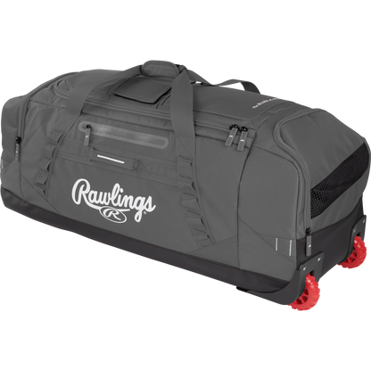 The Rawlings Yadi 2 Wheeled Catcher's Bag (YADI2WHBG) is a large gray equipment bag with black accents, a top handle, multiple zippered compartments, and two red wheels on one end for easy rolling.