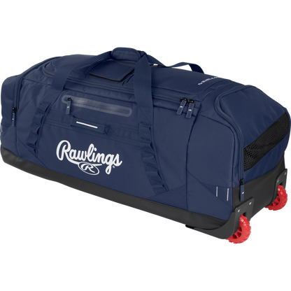 The Rawlings Yadi 2 Wheeled Catcher's Bag (YADI2WHBG) is a large navy blue bag with black accents, side handles, a clear name slot, and two red wheels for easy rolling.