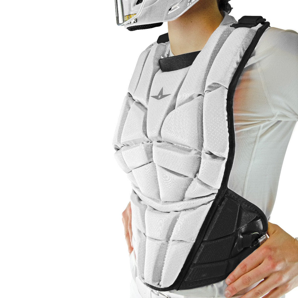 Wearing a white long-sleeve shirt and helmet, a person sports the All Star AFx Fastpitch Catcher's Chest Protector (CPW-AFX), designed for women with segmented padding for superior softball protection.