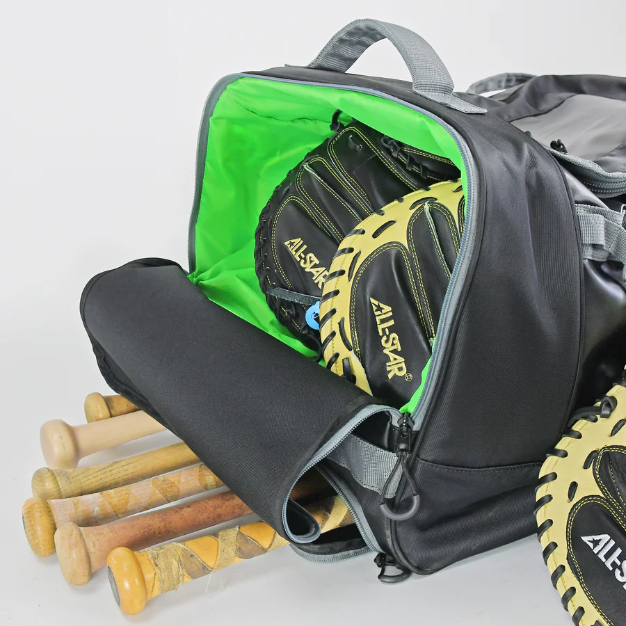 The All Star S7 Elite Catcher's Roller Bag (BB-S7E-RB) in black with a bright green interior is open, showing two baseball gloves inside, while several wooden bats stick out from another compartment.