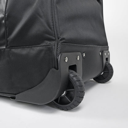 Close-up of the All Star S7 Elite Catcher's Roller Bag (BB-S7E-RB) shows two sturdy black wheels, reinforced edges, and a textured black fabric exterior.