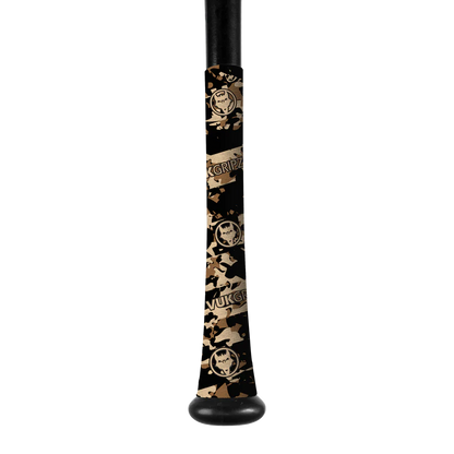 A close-up of a black bat handle wrapped in VukGripz Bat Grip Tape by VukGripz, featuring a camouflage pattern and circular logo for optimal grip. The handle is visible at the top and bottom.