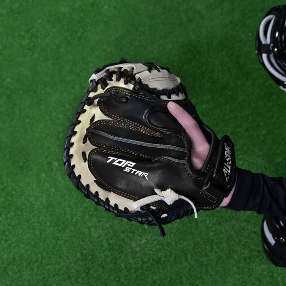 A person holding the All Star Top Star 33.5" Baseball Catcher's Mitt (CM-TS-A) by All Star, crafted from premium steer hide leather and featuring an adjustable wrist closure for a secure fit.