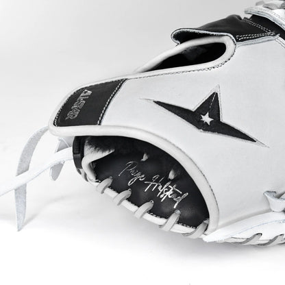 A close-up of the All Star PHX 33″ Paige Halstead Fastpitch Catcher’s Mitt (CMW-PHX-33), a white and black glove featuring the All Star logo, visible stitching, and “Play Grateful” scripted on the palm. This softball catcher’s mitt is designed with an adjustable pocket system to ensure an ideal fit for travel ball players.